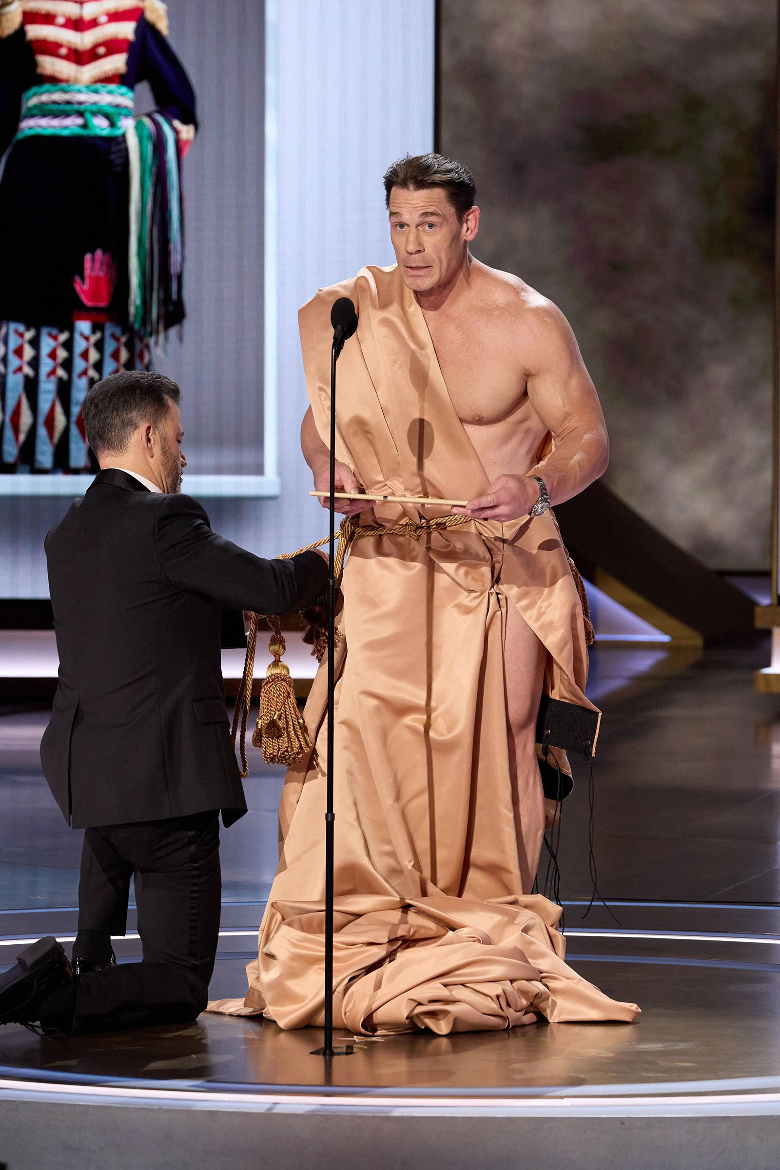 John Cena wearing a toga while presenting the award for Best Costume Design at the 96th Academy Awards at the Dolby Theatre in Hollywood, California on March 10, 2024.