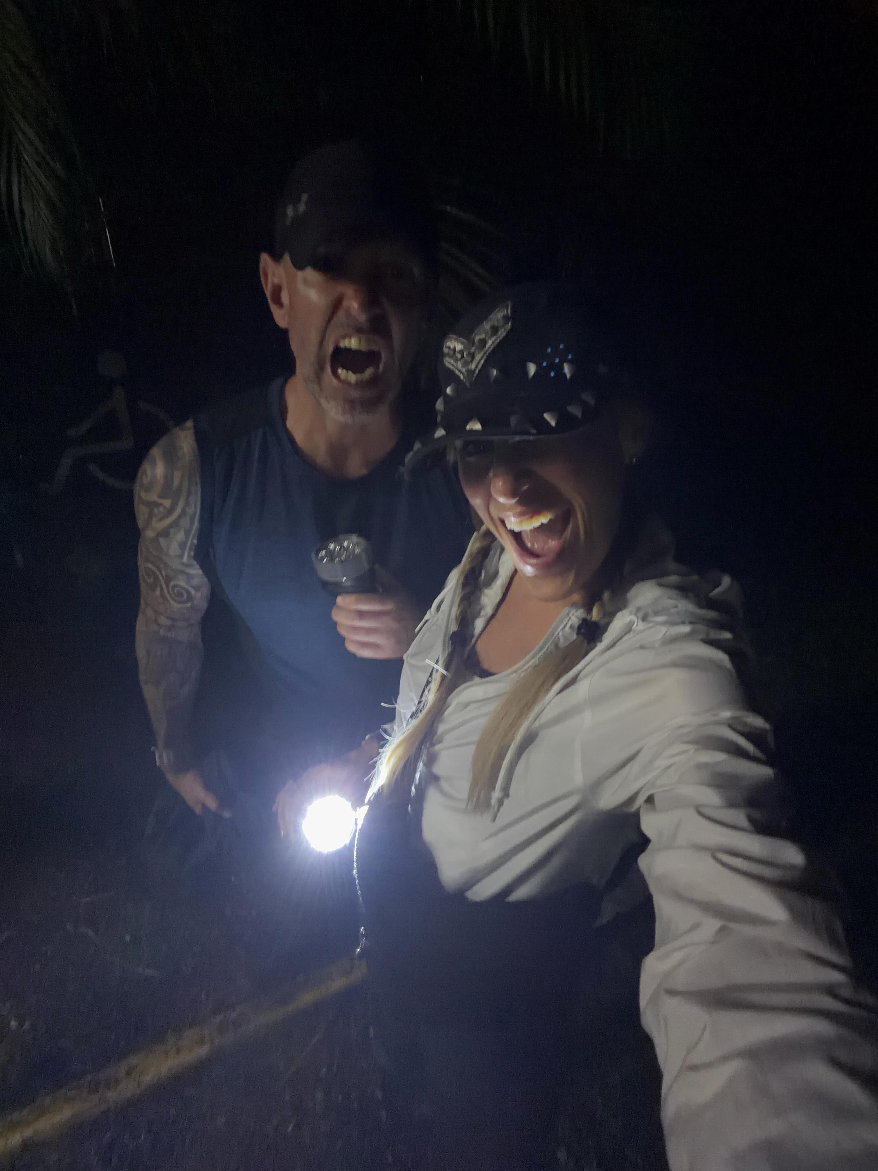 Lilian Garcia and her husband, Patrick Ellrich, exploring a rainforest in La Fortuna, Alajuela, Costa Rica at night